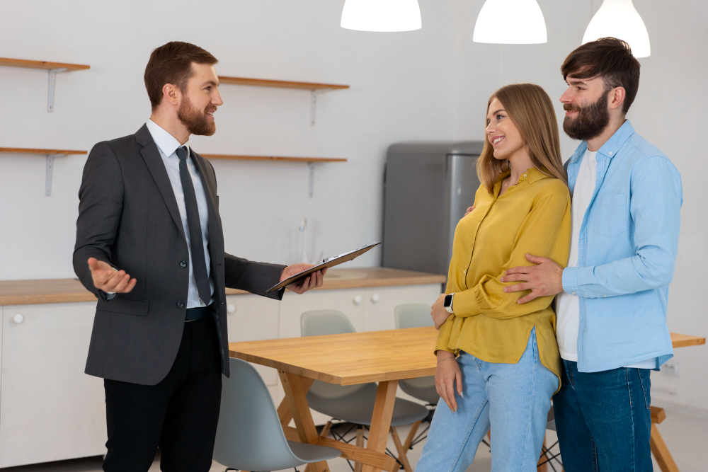 male-real-estate-agent-doing-business-showing-house-potential-buying-couple