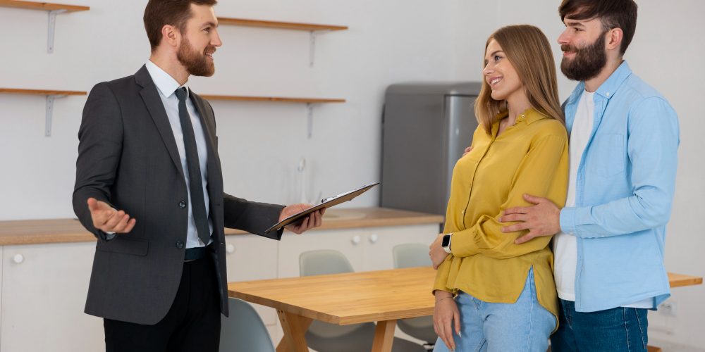 male-real-estate-agent-doing-business-showing-house-potential-buying-couple